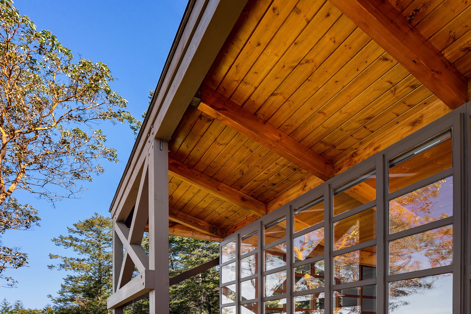 San Juan Island cabin exterior showing painted trim and natural cedar ceiling