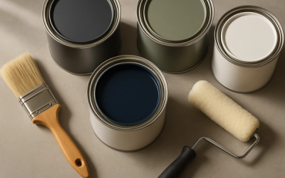 Premium paint cans with high-quality brush and roller on a workshop surface